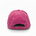 A washed pink cotton baseball cap shown from the back, featuring a curved back strap closure and ventilation eyelets, isolated on a white background.