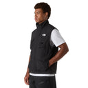 Person wearing a black vest with a brand logo on a white background