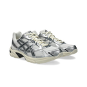 A pair of ASICS Gel-Kayano running shoes in metallic silver and white with cream laces and midsoles, shown on a clean white background.
