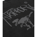 Close-up of a black t-shirt featuring a large gray Stüssy graffiti-style logo and running dog graphic printed on the front.