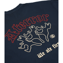 Close-up of a navy blue t-shirt showing the back graphic with the word 'At terror' in red outline, two abstract figures in cream outline, and the phrase 'We ate fire' in cream text.