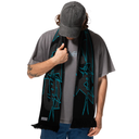 Person wearing a gray t-shirt, black cap, and black scarf with blue designs on a white background