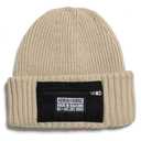 Beige knit beanie with a black patch displaying text on a white background