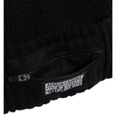 Close-up of a black garment with a visible label on a white background