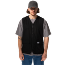 Man wearing a black vest over a gray shirt with a white background