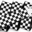 Black and white checkered wristbands stacked on a white surface