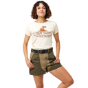 Woman wearing a 'ogue Travel' t-shirt and green shorts on a white background