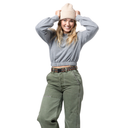 Person wearing a gray sweater, beige beanie, and green pants on a white background