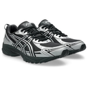 A pair of Asics athletic sneakers in black and silver, shown from a three-quarters angle on a white background.