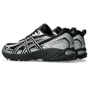 A pair of ASICS athletic sneakers in black and silver, shown from a side profile view against a plain white background.
