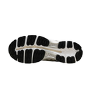 The outsole of a running shoe, showing a black treaded pattern with a white midsole and a beige/gold accent line running horizontally.