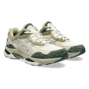 A pair of Asics sneakers in beige, white, and dark green, shown from a three-quarters angle on a white background.