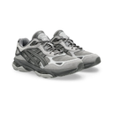 A pair of gray and black athletic sneakers shown from a three-quarters angle on a white background.