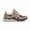 A side-profile view of an ASICS sneaker in beige, dusty rose, and black. The shoe features a beige suede and mesh upper with dusty rose overlays, black side stripes, and a thick brown and beige midsole.