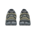 A pair of New Balance 530 sneakers shown from the back, featuring an olive green suede upper, dark gray mesh lining, and a chunky dark gray midsole and outsole.