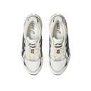 A pair of ASICS sneakers shown from a top-down view on a solid white background. The shoes feature a cream, white, and gray color palette with black and gray accents, including the signature ASICS side stripes.