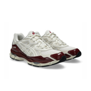 A pair of Asics sneakers in off-white mesh with glossy burgundy overlays and a black outsole, shown on a clean white background.
