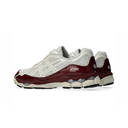 A pair of ASICS sneakers in off-white and deep burgundy, shown from a side profile view against a clean white background.