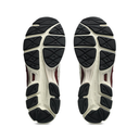 The outsoles of a pair of athletic sneakers, showing a dual-density tread pattern in black and off-white with burgundy accents.