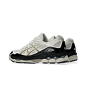 A pair of Asics running shoes in off-white, black, and beige, shown from a side profile view against a plain white background.