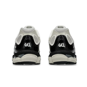 A pair of black and off-white athletic sneakers shown from the back, featuring the 'GEL' logo on the heel and a thick cushioned sole, set against a plain white background.