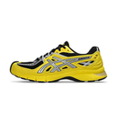 Yellow running shoe with black and gray accents on a white background