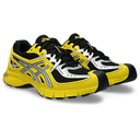 Yellow and black running shoes with white accents on a white background