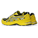 Yellow running shoes with black accents on a white background