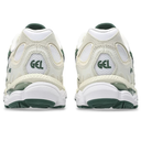 Pair of white running shoes with green accents on a white background