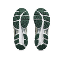 Close-up of green and white athletic shoe soles on a white background