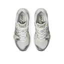 Pair of white running shoes with black accents on a white background