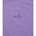 A close-up of a lavender purple fabric surface with a small embroidered logo in a darker purple/magenta thread.