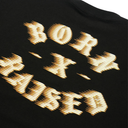 Close-up of a black t-shirt featuring a large, stylized metallic gold graphic text that reads 'BORN TO BE'.