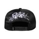 Black snapback cap shown from the back, featuring a white embroidered graphic of two bulldogs with starburst accents on the front panels and a black adjustable strap.