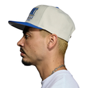 A man shown in profile wearing a white and blue snapback cap with 'BOSTON WORLD SERIES' printed on the front, against a plain white background.