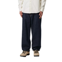 Person wearing dark blue jeans and beige boots on a white background