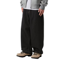 Person wearing black wide-leg pants with a plain background