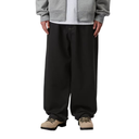 Person wearing black pants with a plain background