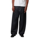 Person wearing dark jeans and black shoes on a white background