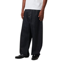 Person wearing black wide-leg jeans and black shoes on a white background