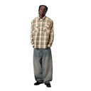 Person wearing a plaid shirt and wide-leg jeans on a white background