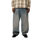 Person wearing a plaid shirt and blue jeans on a white background