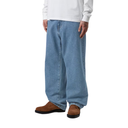 Person wearing light blue jeans and brown shoes on a white background