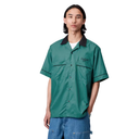 Person wearing a green short-sleeve shirt with black collar on a white background