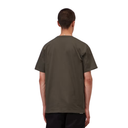 A man viewed from behind wearing a dark olive green short-sleeve t-shirt and black pants, set against a plain white background.