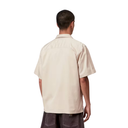 Man wearing a beige shirt on a white background