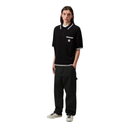 Person wearing a black polo shirt and pants on a white background