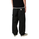 Person wearing black cargo pants with a white stripe on a white background