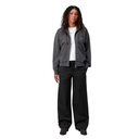 Person wearing a gray jacket and black pants on a white background