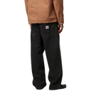 Person wearing a brown jacket and black pants on a white background